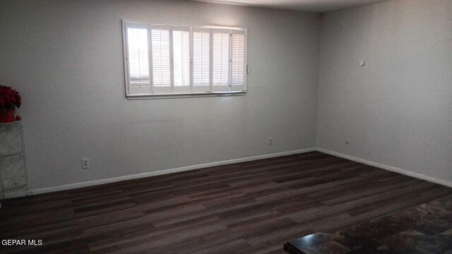 8808 Cosmos Ave, El Paso, TX 79925 - spare room with baseboards and dark wood-style flooring