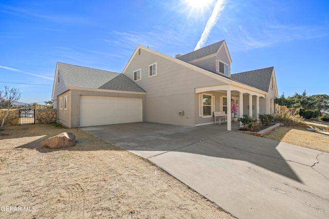 view of front of home with a porch and a garage