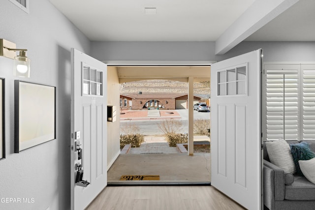 doorway with hardwood / wood-style flooring