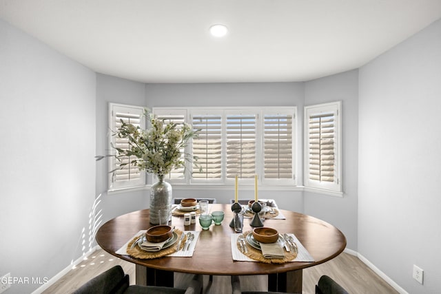 dining space with wood-type flooring