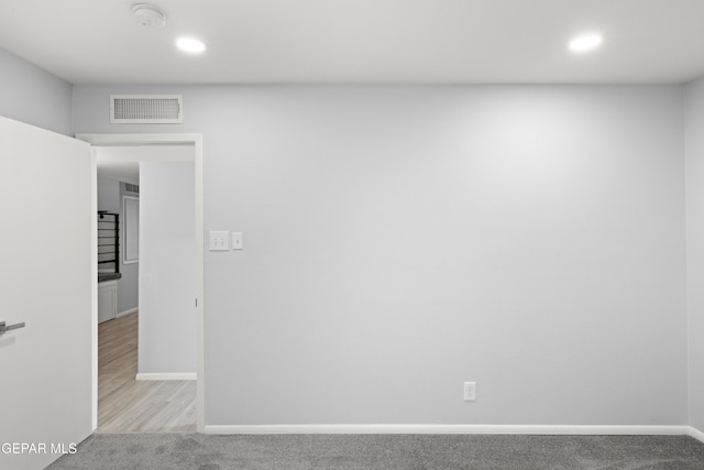 empty room featuring light colored carpet