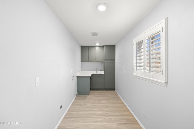 interior space with sink and light wood-type flooring