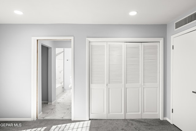 unfurnished bedroom featuring carpet and a closet