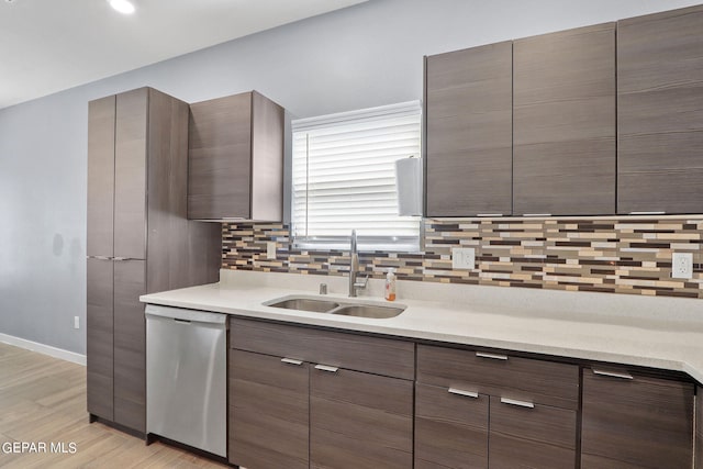 kitchen with sink, tasteful backsplash, dark brown cabinetry, light hardwood / wood-style floors, and stainless steel dishwasher