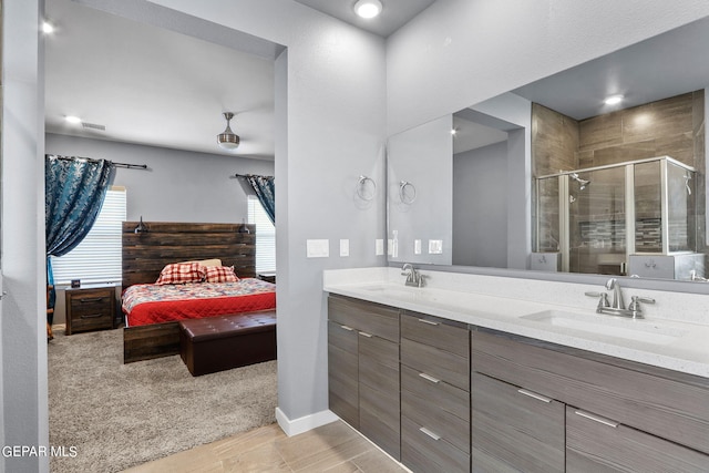 bathroom featuring vanity and a shower with door