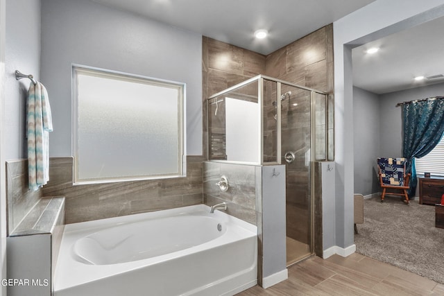 bathroom with separate shower and tub