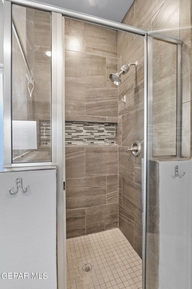 bathroom with tiled shower