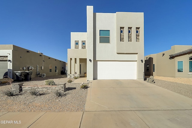 pueblo-style house with a garage