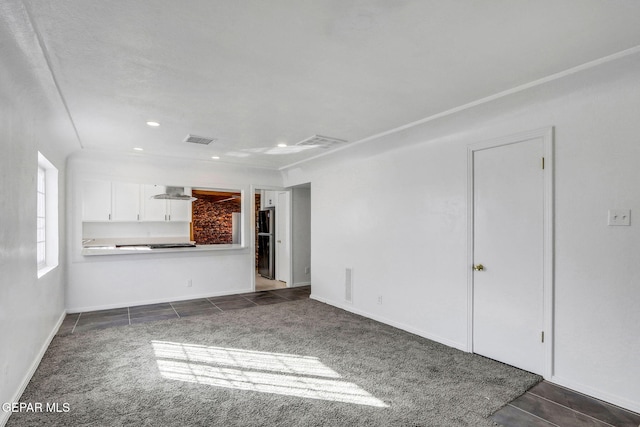 unfurnished living room with dark carpet