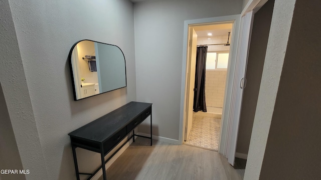 corridor with light hardwood / wood-style floors