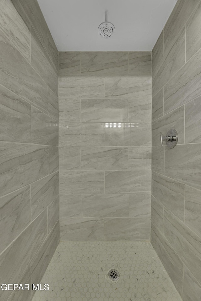 bathroom with a tile shower