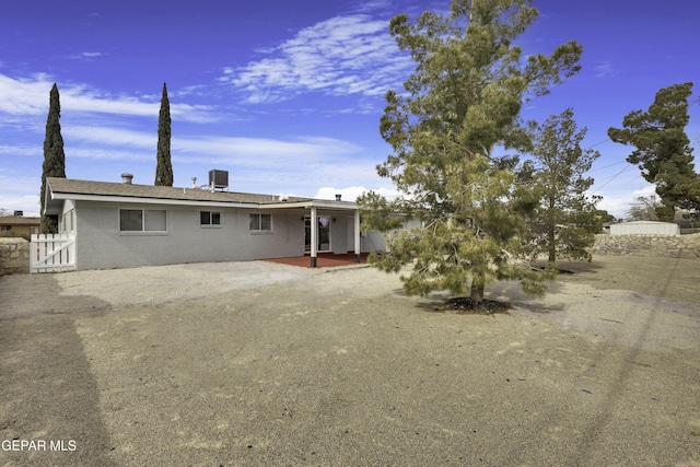 view of front of property featuring cooling unit and a patio