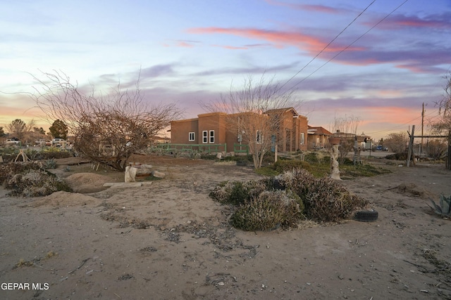 view of back house at dusk