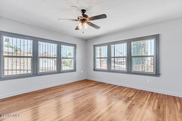 empty room featuring ceiling fan and light hardwood / wood-style floors