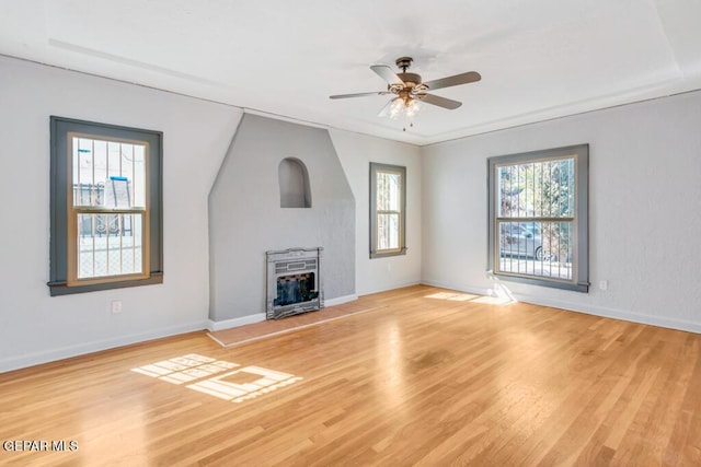 unfurnished living room featuring ceiling fan and light hardwood / wood-style floors