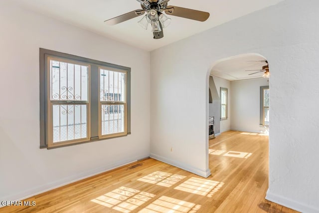 empty room featuring ceiling fan and light hardwood / wood-style flooring