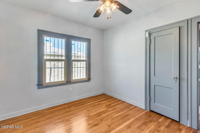 empty room with ceiling fan and light wood-type flooring