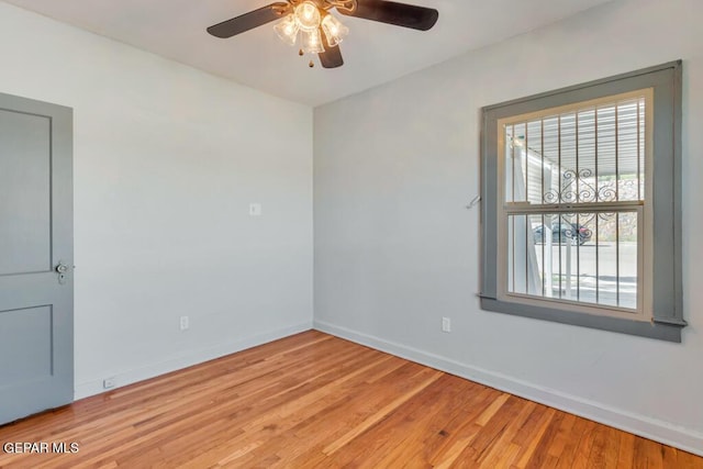 unfurnished room with hardwood / wood-style floors and ceiling fan