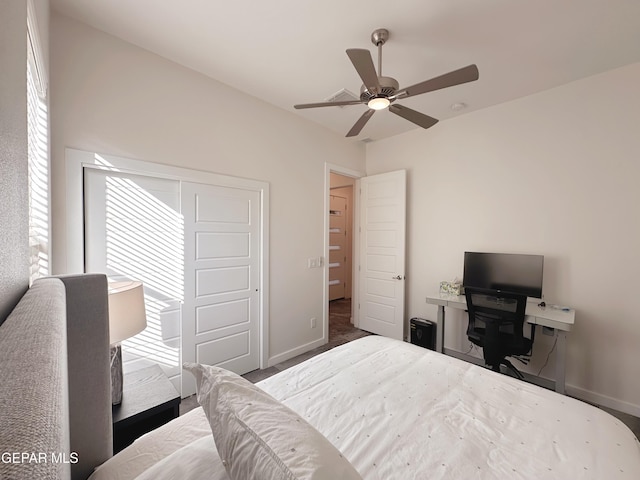 bedroom featuring ceiling fan, a closet, and dark colored carpet