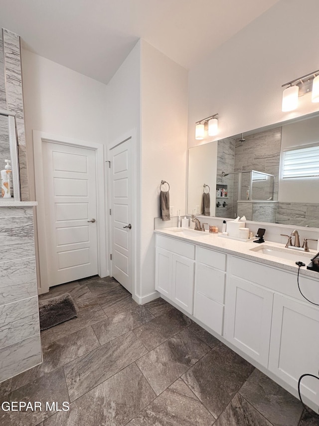 bathroom featuring vanity and tiled shower