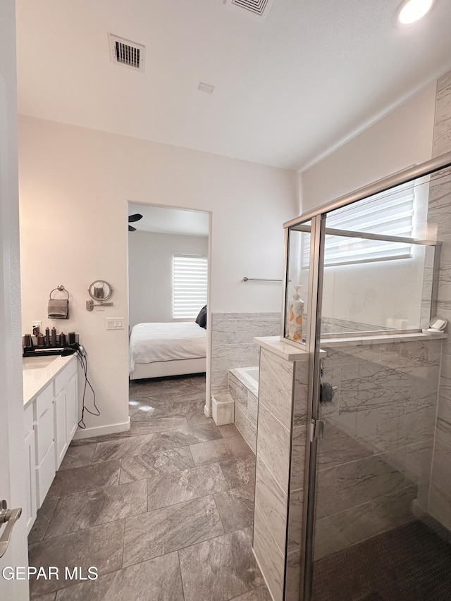 bathroom featuring vanity and shower with separate bathtub