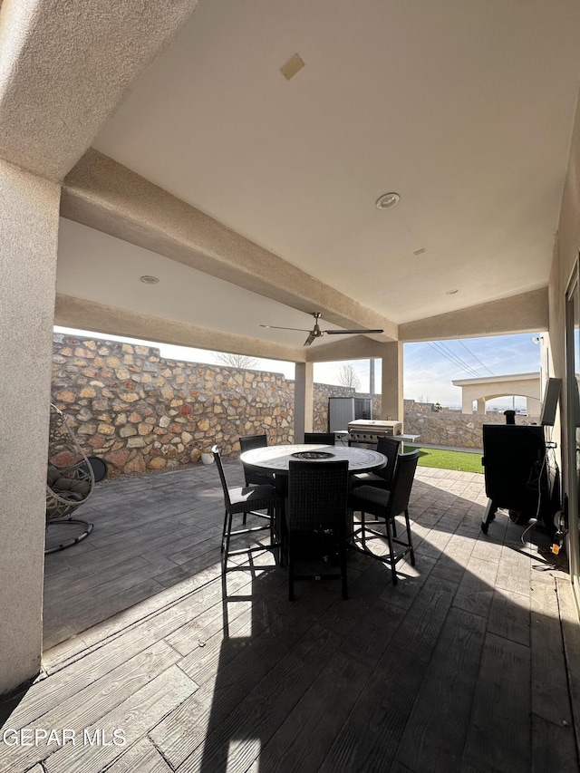 wooden terrace featuring ceiling fan and a patio