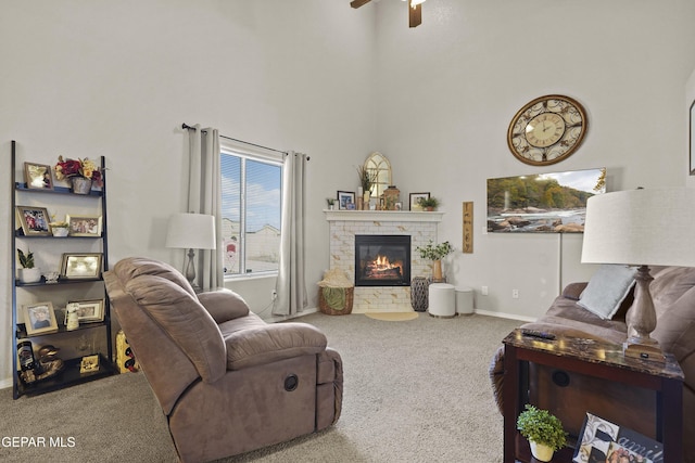 carpeted living room with a towering ceiling and ceiling fan