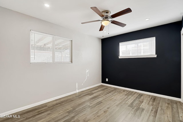 unfurnished room with ceiling fan and light hardwood / wood-style flooring