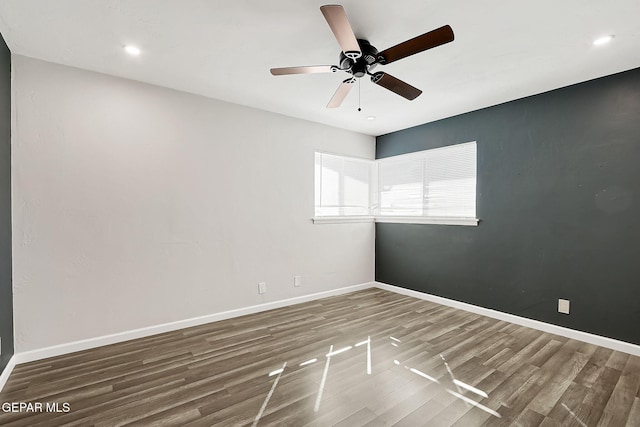 spare room featuring hardwood / wood-style floors and ceiling fan