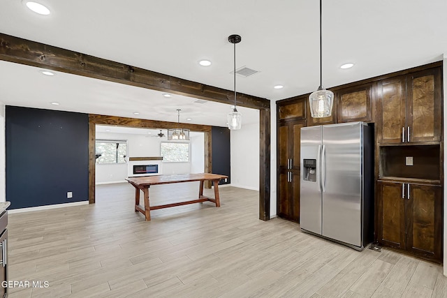 kitchen with dark brown cabinetry, stainless steel fridge, hanging light fixtures, and beam ceiling