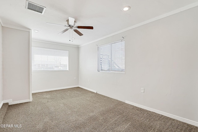 empty room with crown molding, carpet floors, and ceiling fan