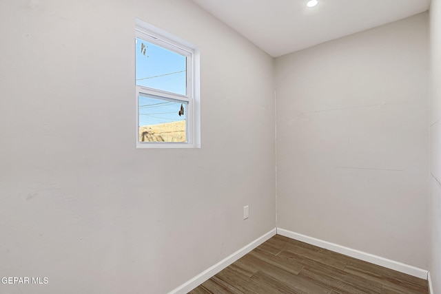 empty room with dark hardwood / wood-style flooring