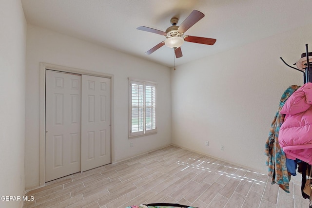 unfurnished bedroom with light hardwood / wood-style floors, a closet, and ceiling fan