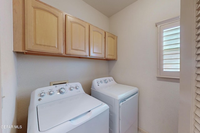 laundry room featuring cabinets and washing machine and clothes dryer