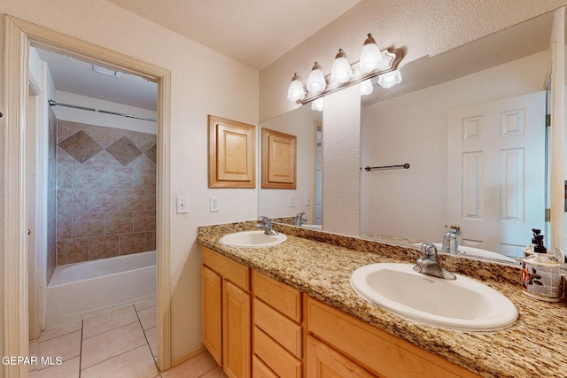 bathroom with vanity, tiled shower / bath combo, and tile patterned flooring