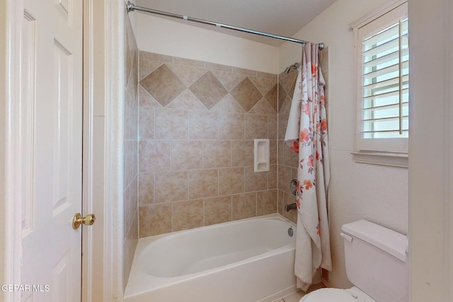 bathroom with shower / bathtub combination with curtain and toilet