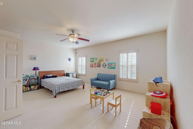 bedroom with ceiling fan and multiple windows