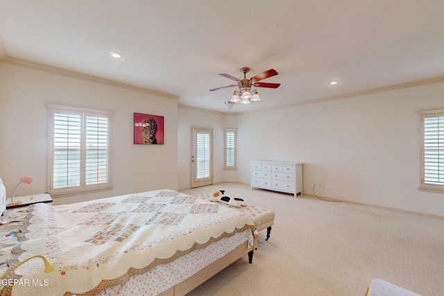 carpeted bedroom featuring crown molding and ceiling fan