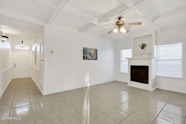 unfurnished living room with beamed ceiling, coffered ceiling, light tile patterned floors, and ceiling fan