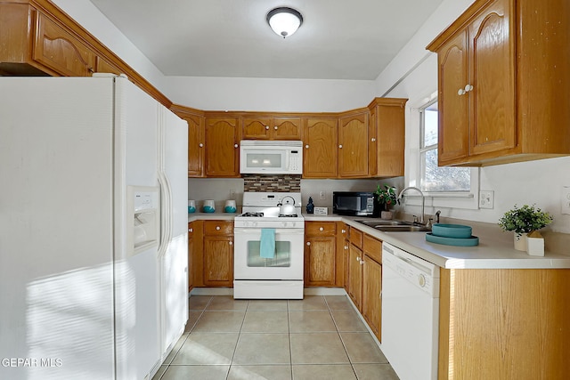 kitchen with tasteful backsplash, sink, light tile patterned floors, and white appliances