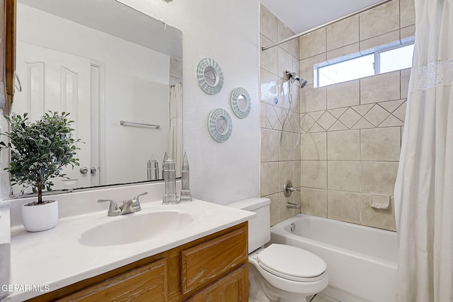 full bathroom featuring vanity, shower / tub combo, and toilet