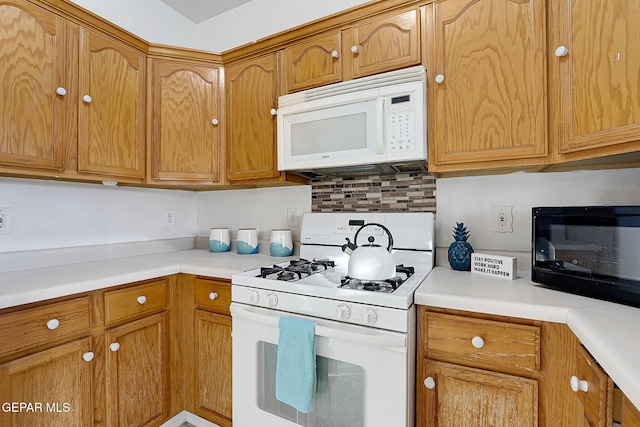 kitchen with white appliances and decorative backsplash