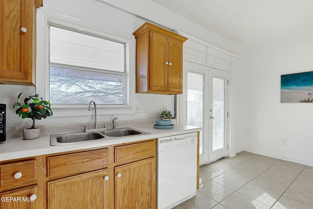 kitchen with sink, light tile patterned floors, white dishwasher, and french doors