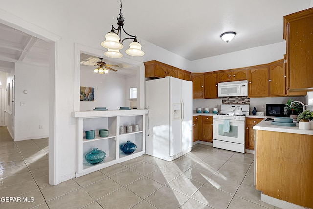 kitchen featuring pendant lighting, light tile patterned floors, white appliances, and tasteful backsplash