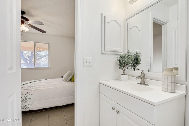 bathroom with vanity, a textured ceiling, tile patterned floors, and ceiling fan