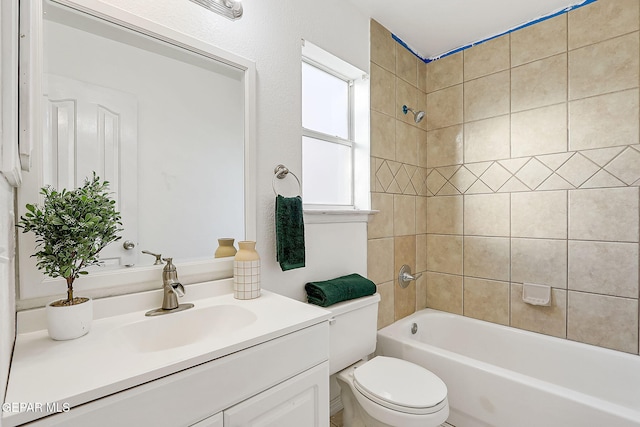 full bathroom with tiled shower / bath, vanity, and toilet