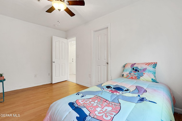 bedroom with hardwood / wood-style floors and ceiling fan