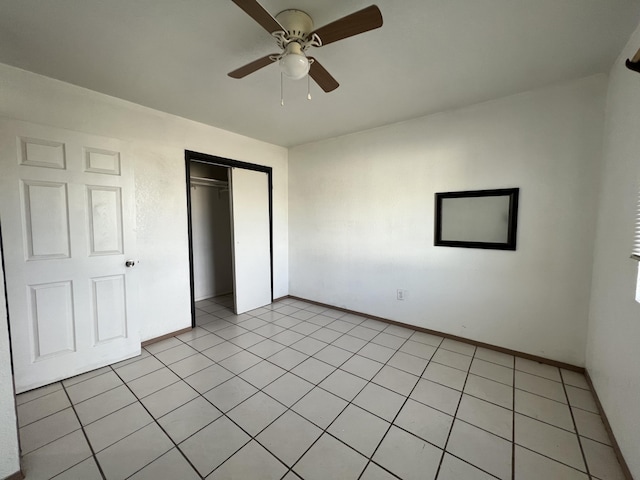 unfurnished bedroom featuring light tile patterned floors, a closet, and ceiling fan