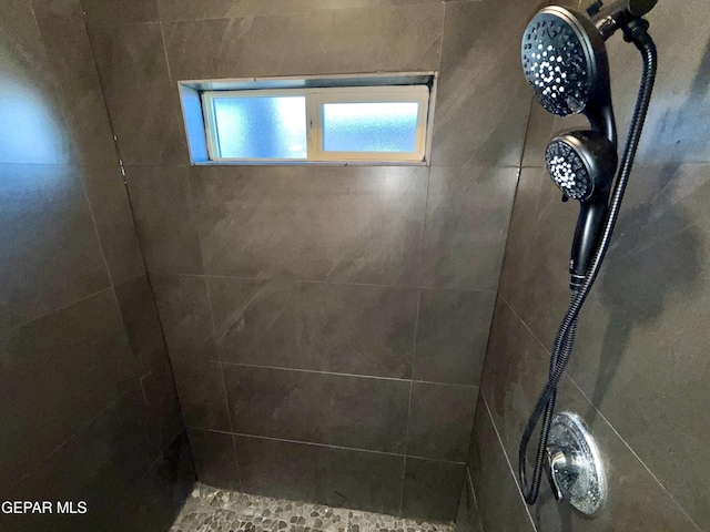 bathroom with tiled shower