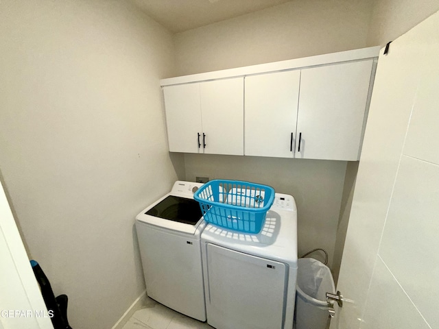 laundry area featuring washer and clothes dryer and cabinets